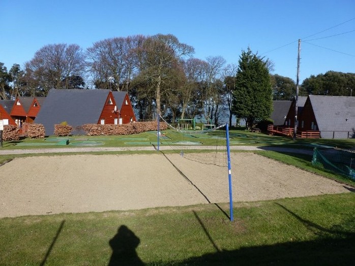 View of volleyball court with chalets behind