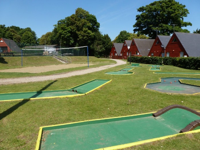 View of the golf course with chalets behind